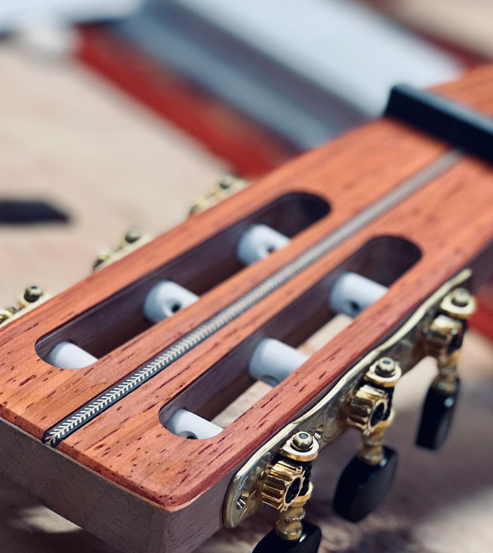 Slotted headstock with gold tuners — close detail of a SugarTree build.